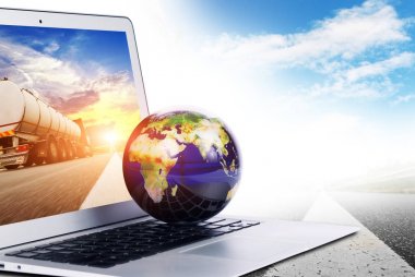 World globe on the silver laptop with truck on screen isolated on white background clipart