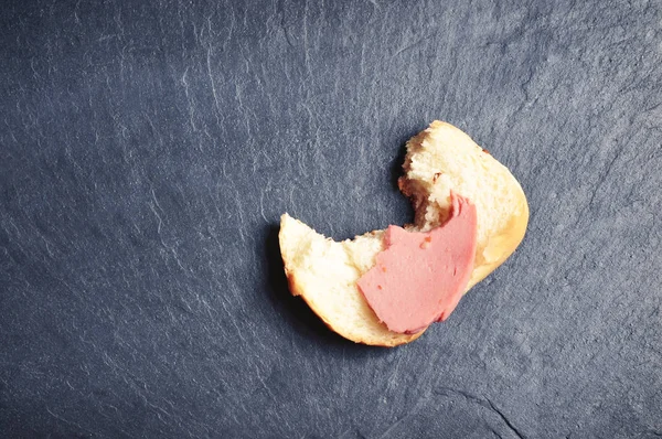 Кусанный Сэндвич Колбасой Белым Хлебом Темно Синем Фоне — стоковое фото