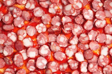 Pizza hamur üzerinde kırmızı ketçap soslu sosis dilimleri Close-Up