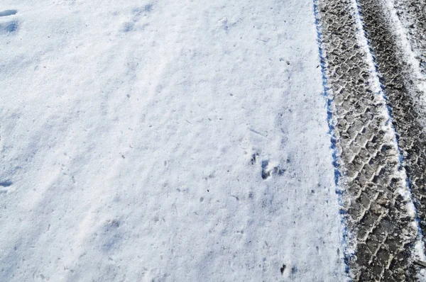 Spår Ett Bildäck Vägen Täckt Vit Snö — Stockfoto