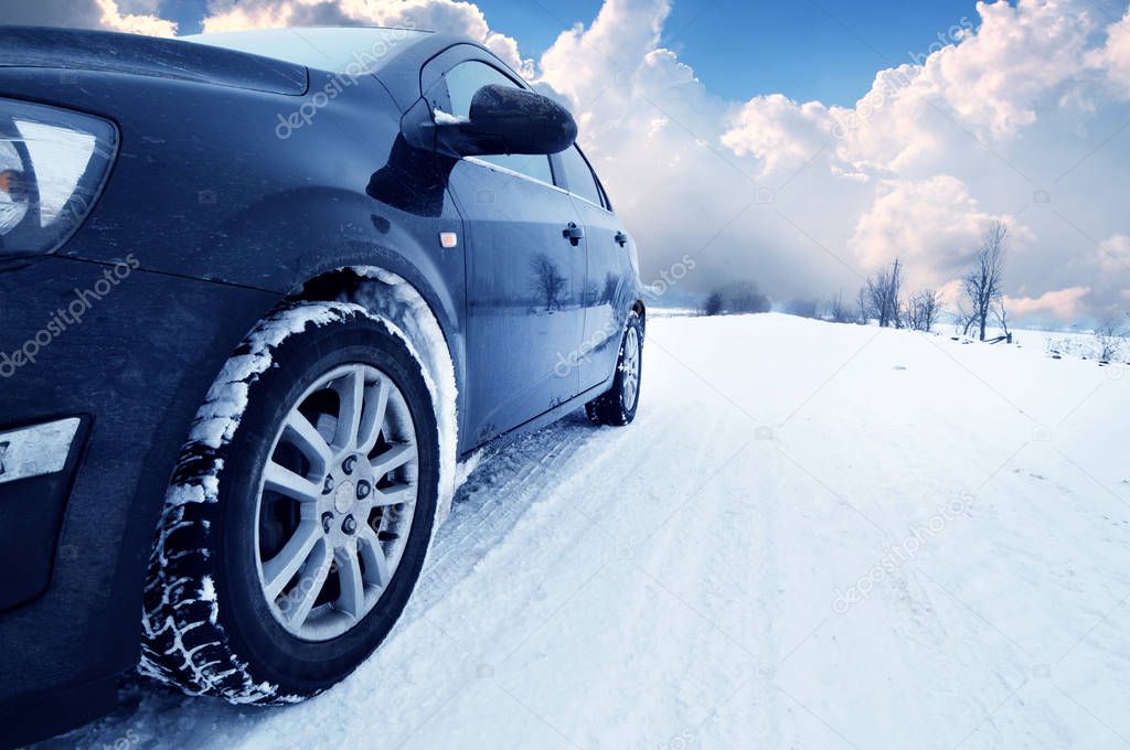 Black car at winte on the snowy road