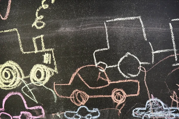 Hand drawn different colorful cars on chalk board