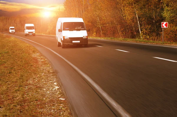 Three White Commercial Vans Countryside Road Motion Forest Sky Sunset — Stock Photo, Image
