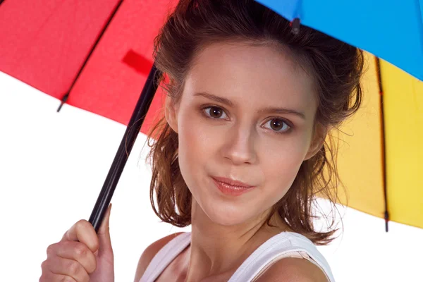 Smiling young brunette woman in white blouse with umbrella