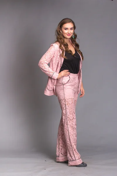 Portrait of a happy woman pink suit — Stock Photo, Image