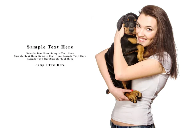 Brunette girl with her puppy isolated on white background — Stock Photo, Image