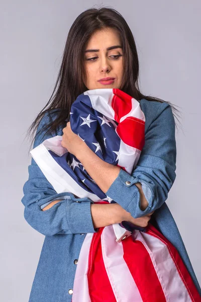 Bandera de Estados Unidos de América en manos de una mujer hermosa y triste — Foto de Stock