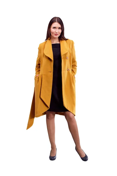 Портрет девушки в желтом пальто, позирующей на светлой спине — стоковое фото