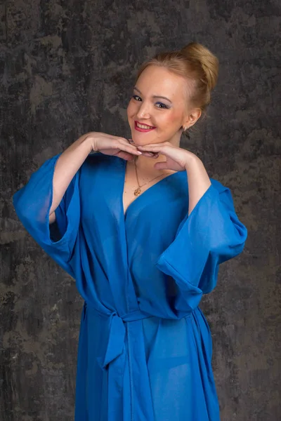 Beautiful breast in blue bathrobe — Stock Photo, Image