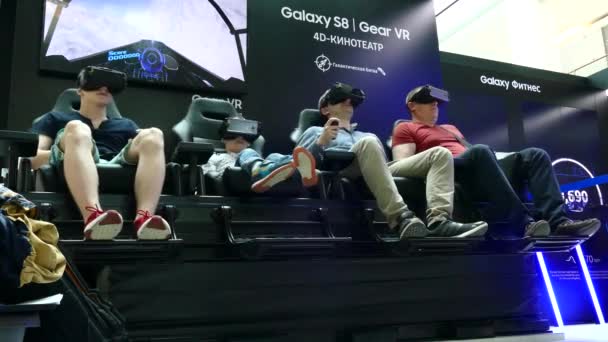 Personas con una experiencia de visualización de contenido VR inmersiva en el Samsung Gear VR Theater con silla 4D — Vídeo de stock