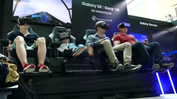 Personas con una experiencia de visualización de contenido VR inmersiva en el Samsung Gear VR Theater con silla 4D — Vídeo de stock