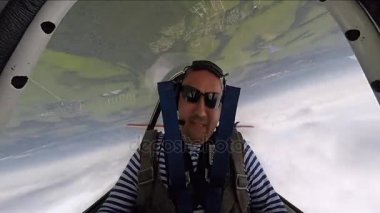 Akrobasi küçük Yakovlev 52 uçakta gerçekleştirirken aşırı yüklenme sahip adam.