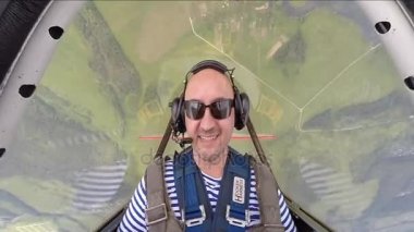 Gökyüzünde akrobasi uçağı kabinde oturan komik adam