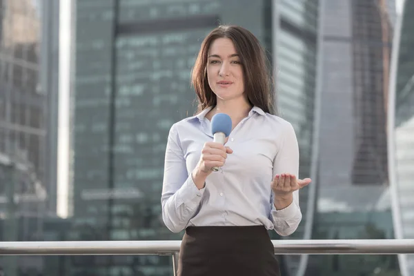 journalist is reporting on a business center background