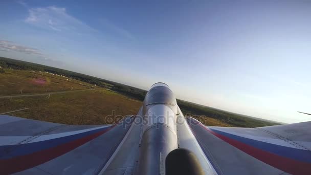View from action camera from tale of aerobatic jet aircraft in air. — Stock Video