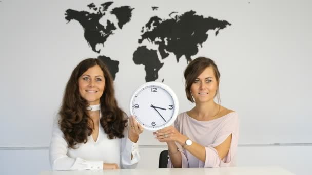 Two Girls Table Studio Holding Clock Arrows Hands — Stock Video