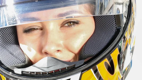 Woman in motocross helmet, close up view