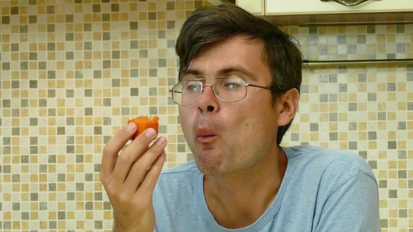 Adult man eating carrot on the morning — Stock Photo, Image