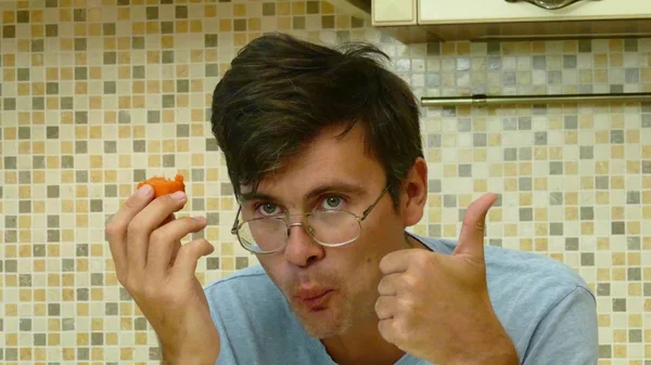 Adult man eating carrot on the morning — Stock Photo, Image