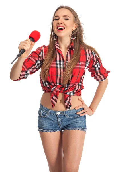 Woman singing karaoke with microphone — Stock Photo, Image