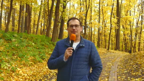 Journalist mit Mikrofon vor orthodoxer Kirche. — Stockvideo