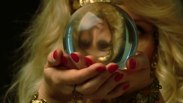 Kvinnliga fortune teller ser framtiden genom kristallkula. Nära håll view. — Stockvideo