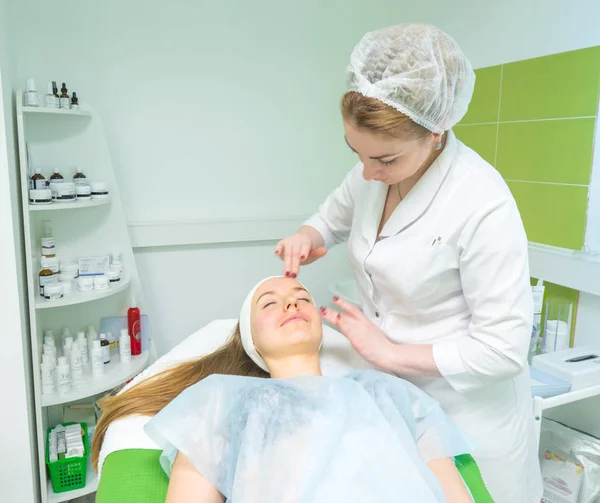 Doctor massaging patient's face. — Stock Photo, Image