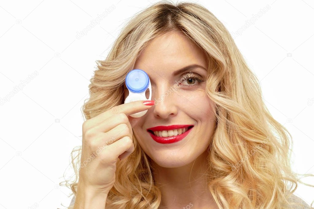Beautiful blond woman with contact lenses box.