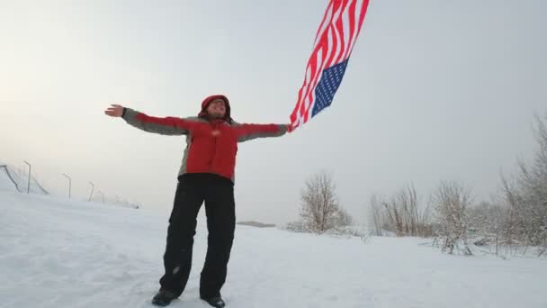 Homem com bandeira dos EUA numa pista de esqui — Vídeo de Stock