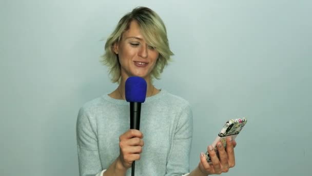 Girl reads text in microphone — Stock Video