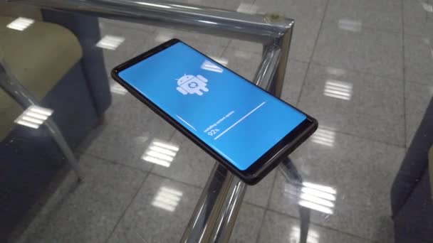 Εικονίδιο με το λογότυπο Android ρομπότ στην οθόνη του έξυπνου τηλεφώνου κατά τη διάρκεια της εγκατάστασης της ενημερωμένης έκδοσης — Αρχείο Βίντεο