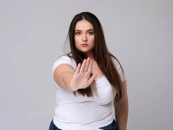 Plus Size Model with long hair gesturing no signal in studio. — Stock Photo, Image