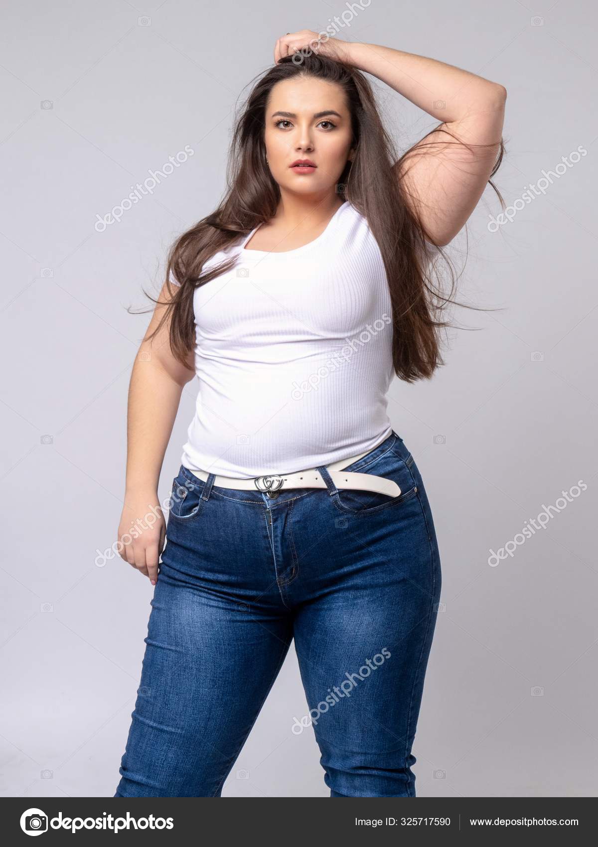 Plus Size Model with long hair posing in studio Stock Photo by ...