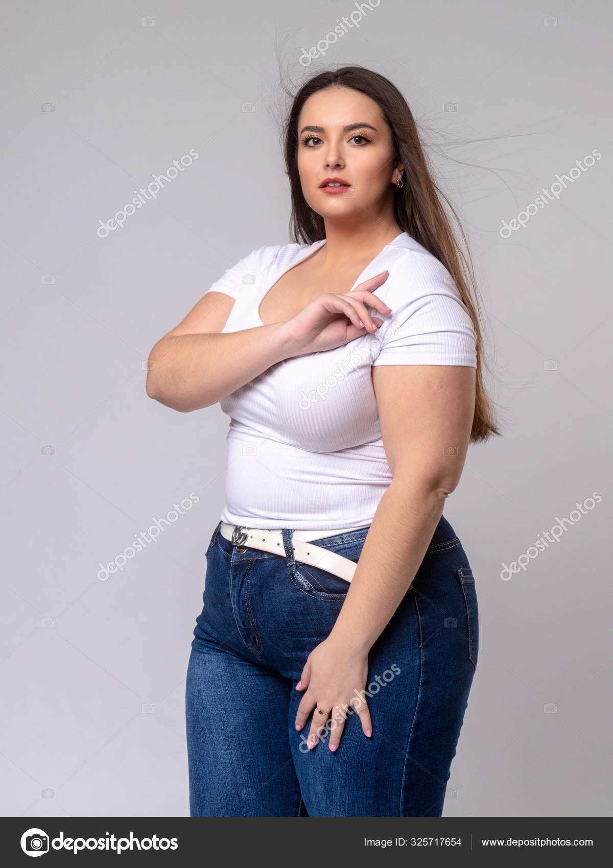 Plus Size Model with long hair posing studio Stock Photo by ©gsdonlin 325717654