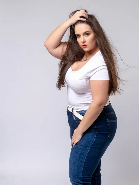 Plus Size Model with long hair posing in studio — Stock Photo, Image