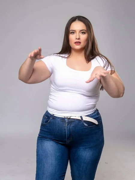 Plus Size Model with long hair posing in studio — Stock Photo, Image