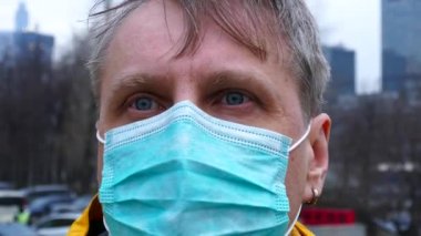 Adult man in medical mask close up portrait