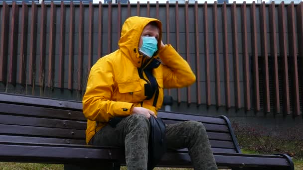 Sick man in medical mask corrects it — Stock video