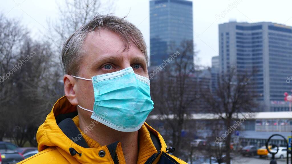 Portrait of a gray-haired man in a medical mask