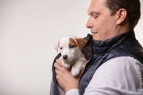 Man houdt een puppy in zijn handen — Stockfoto