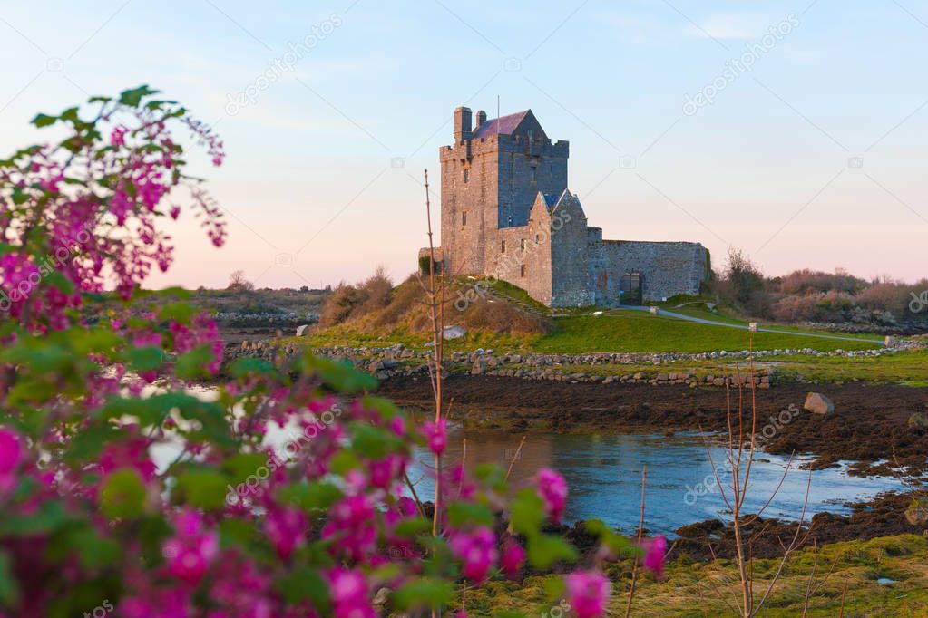 Castle on the bank of ocean bay during sunset