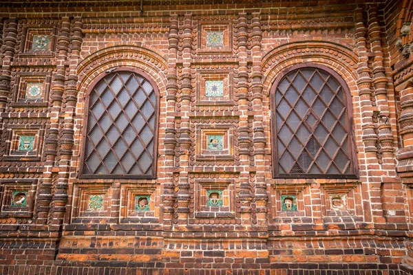 Antique windows in a red brick wall — Stock Photo, Image