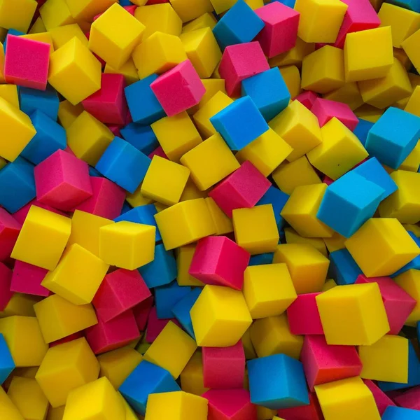 Colored foam rubber cubes background — Stock Photo, Image
