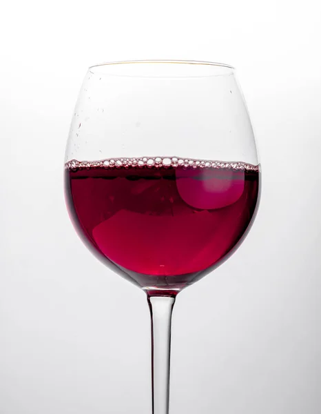 Glass of red wine close-up over white background — Stock Photo, Image