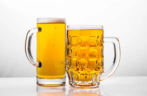 Two Mugs of fresh beer with cap foam — Stock Photo, Image