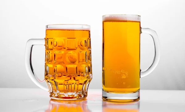 Two Mugs of fresh beer with cap foam — Stock Photo, Image