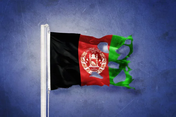 Torn flag of Afghanistan flying against grunge background — Stock Photo, Image