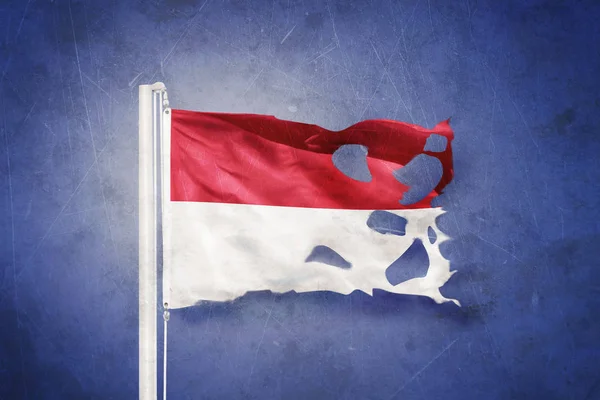 Torn flag of Monaco flying against grunge background — Stock Photo, Image