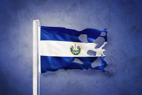 Torn flag of El Salvador flying against grunge background — Stock Photo, Image