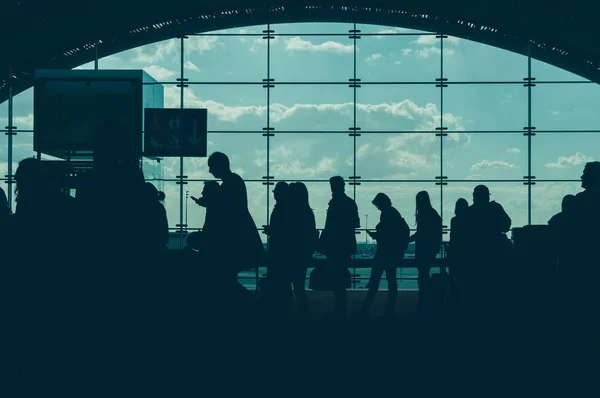 Traveling concept. Airport terminal blurred crowd of travelling people on the background. vintage color tone — Stock Photo, Image